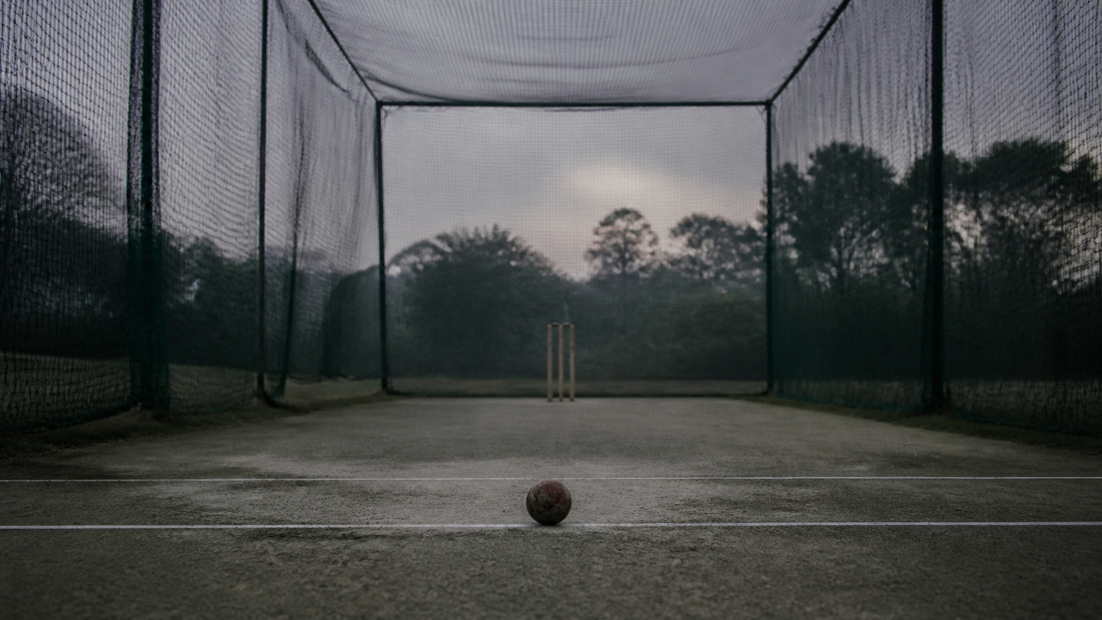 An empty cricket batting net at dawn
